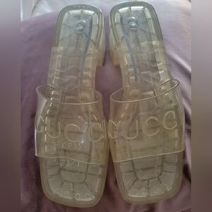Gucci Clear rubber materials embossed logo.